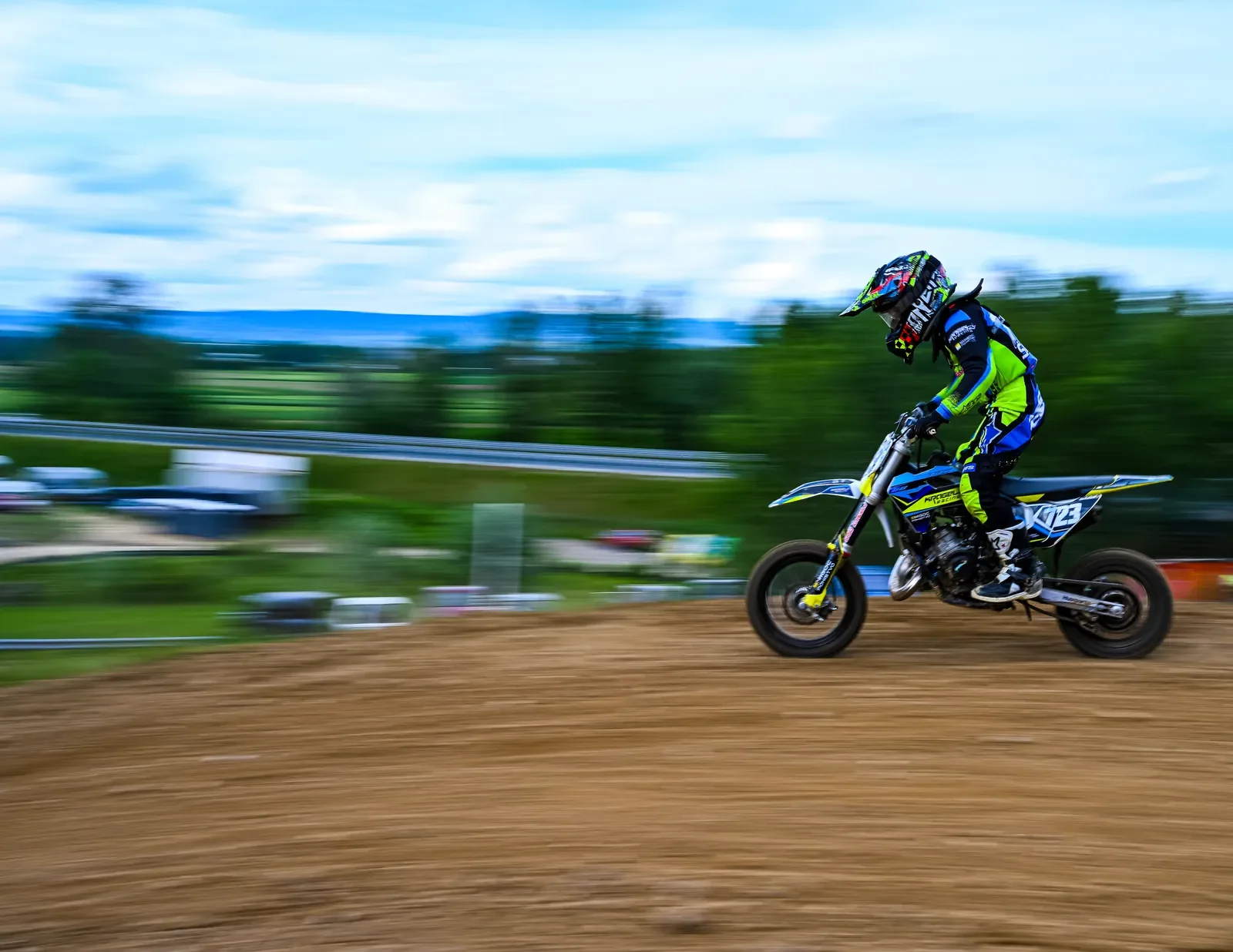 Motocross rider shot with a panning camera, background blurred by speed